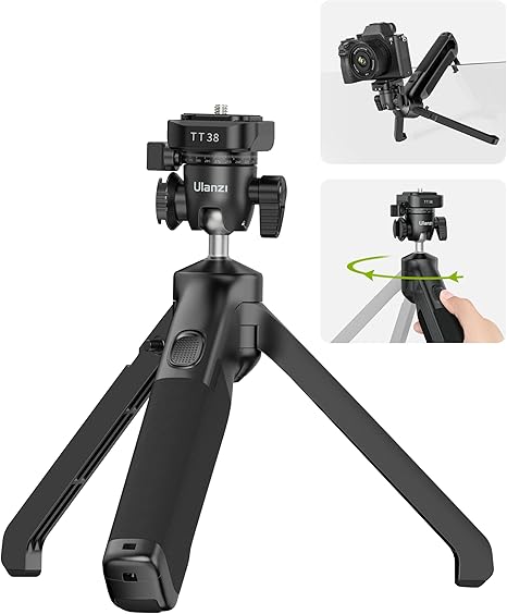 The TT38 tripod fully extended with a mirrorless camera mounted, set against a scenic outdoor background